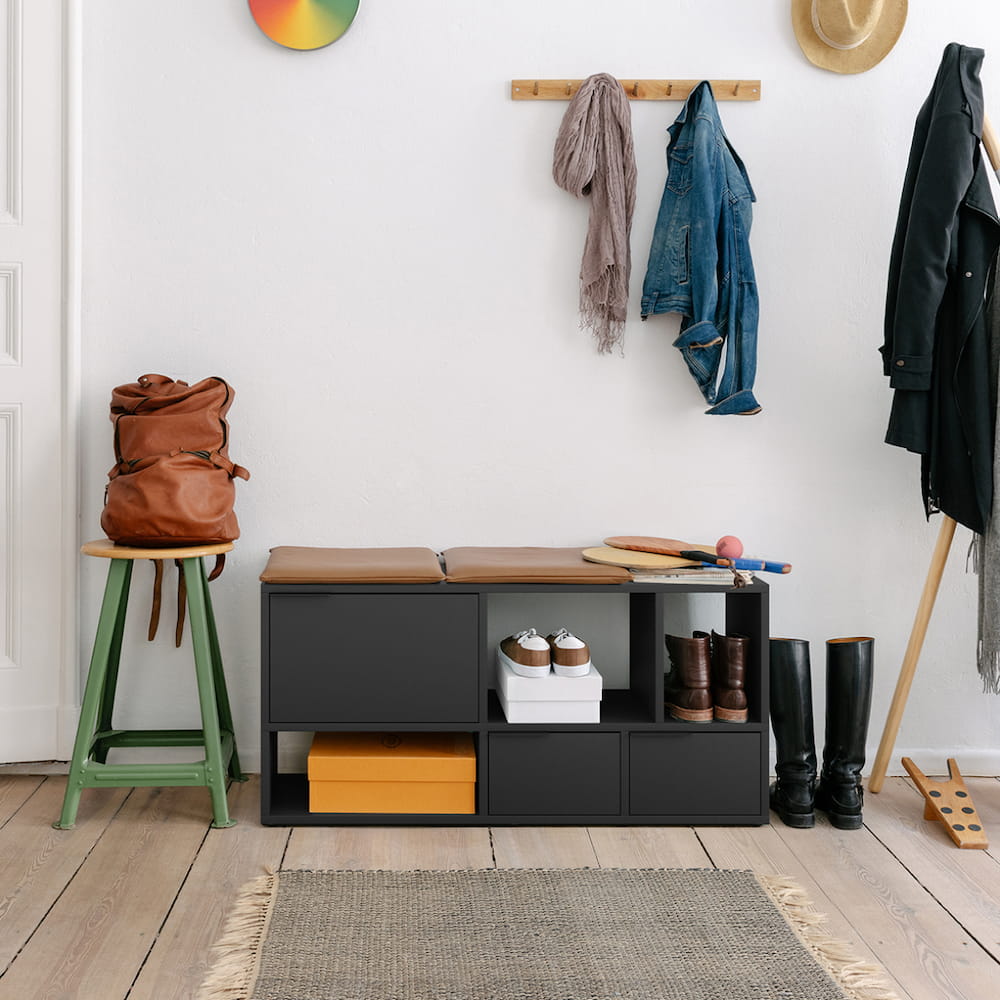 A compact, cool Type02 Shoe Rack in Midnight Blue stands in a neat hallway with 3 rows of mixed open and closed storage.